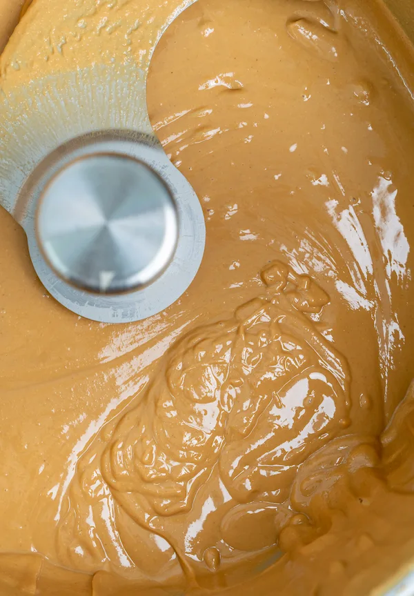 Old-school grinding and blending of roasted nuts into natural nut butter